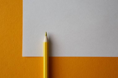 Sarı renkli kalem parlak sarı ve beyaz arkaplanda yatıyor, makro fotoğraf..