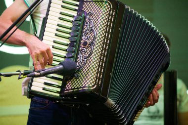 Erkek bir müzisyenin elindeki müzik aleti akordeonu. Kültür ve sanat kavramı.
