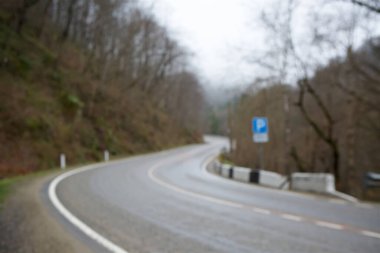 Yolun kenarındaki orman yollarının bulanık arkaplanı bulanıklaşmış..