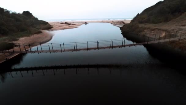 Voetgangersbrug over de rivier van de kust — Stockvideo
