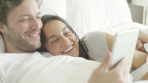 Couple relaxing in bed — Stock Video