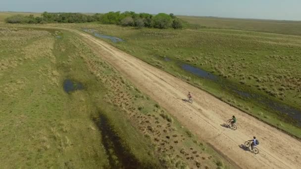 Cyclists on dirt road, Ibera Wetlands, Corrientes Province, Argentina — Stock Video