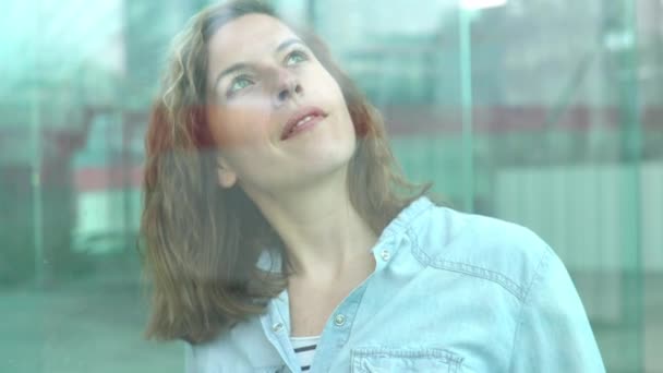 Woman looking through window — Stock Video