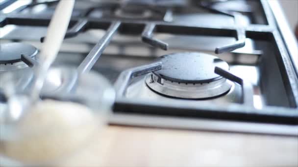 Frying pan being put on gas stove — Αρχείο Βίντεο