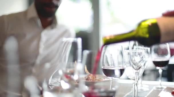 Close-up of red wine being poured into glass — Stock Video