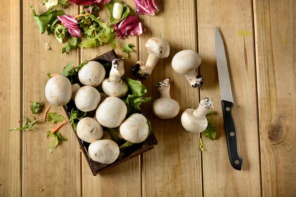 Champignon mushrooms on wooden table — Stock Photo, Image