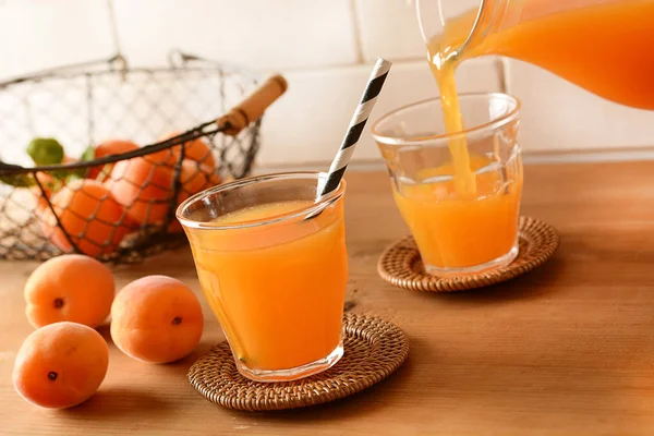 Apricot juice in the glass with fruit around — Stock Photo, Image