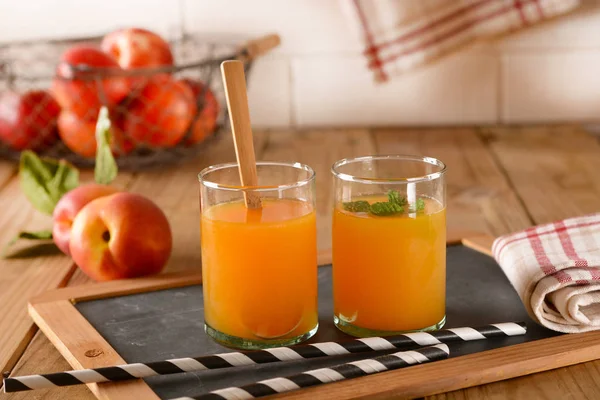 Peach drink with mint leaves in the glass