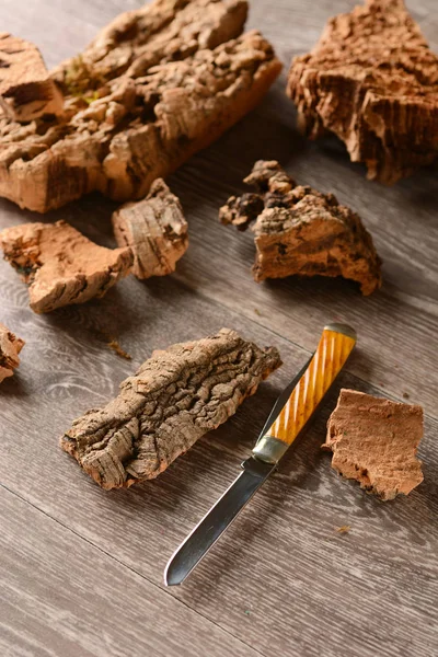 Bark of cork on the table with the knife — Stock Photo, Image