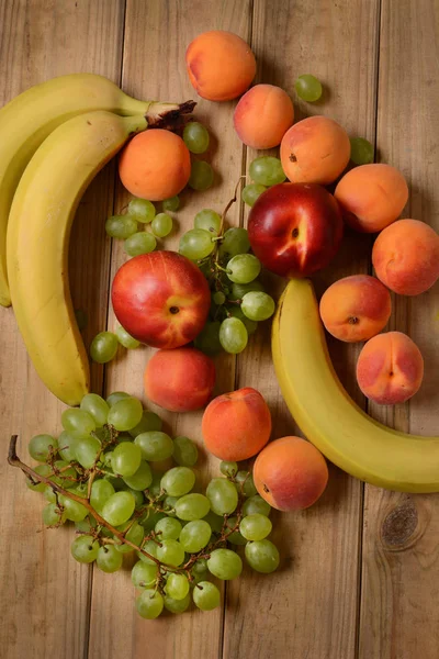 Assorted fruit on wooden table — Stock Photo, Image