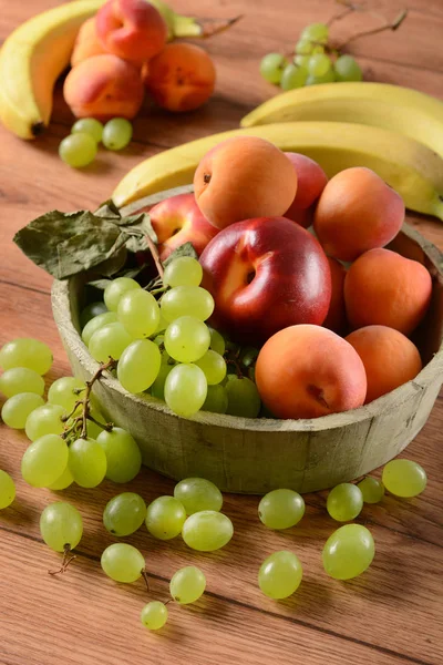 Assorted fruit on wooden table — Stock Photo, Image