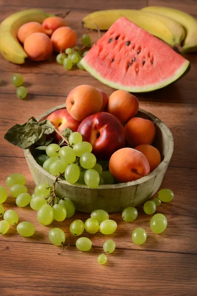 Assorted fruit on wooden table — Stock Photo, Image