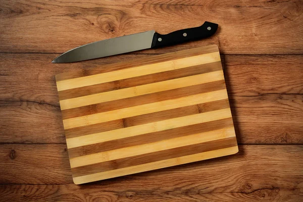 Wooden cutting board with knife