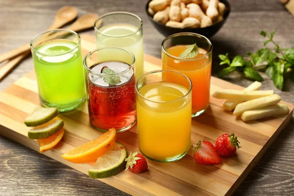 Assorted fruit juices with ingredients around — Stock Photo, Image
