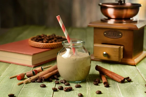 Coffee yoghurt in glass jar on green wooden table — Stock Photo, Image