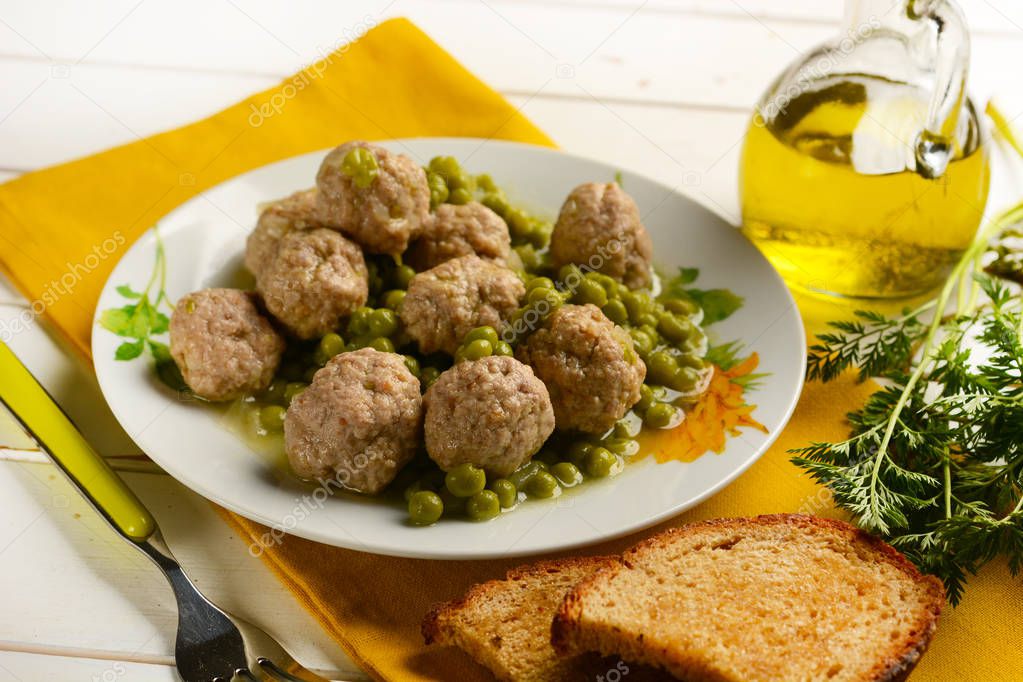 meatballs with peas garnish in white plate