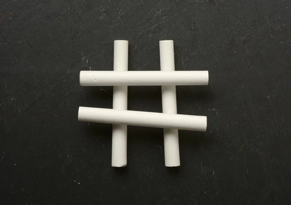 The hashtag symbol made with chalks - black background — Stock Photo, Image