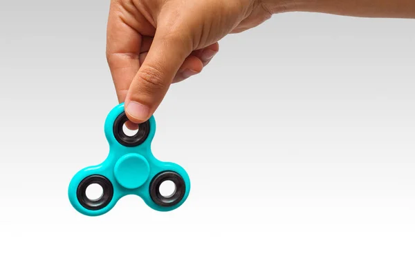 Close-up of a young man playing with a fidget spinner — Stock Photo, Image