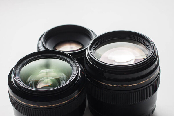 close-up view of a group of camera lenses on a white surface