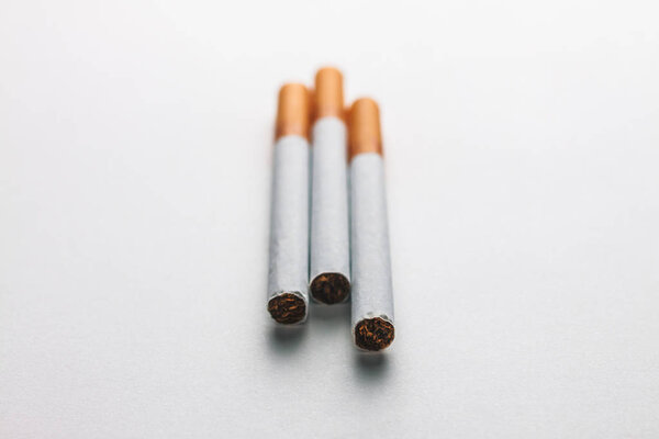 Close-up of a group of cigarettes on a blank surface