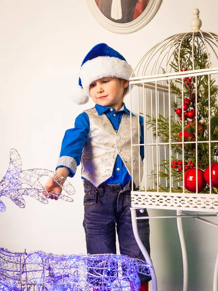 Smiling boy  in the studio in the New Year decorations — Stock Photo, Image