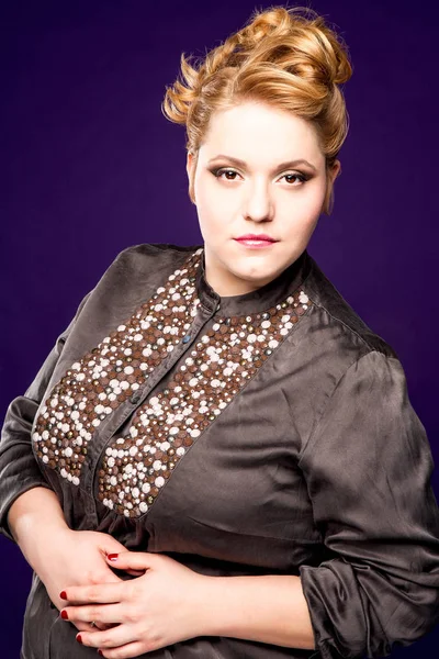 Beautiful fat girl with honey-colored hair on a black background