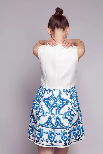 Young girl in white dress with ethnic pattern of blue color — Stock Photo, Image