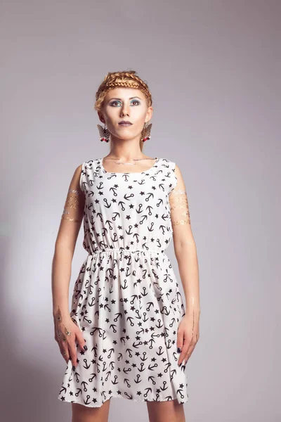 Young girl in a white dress with a pattern of black anchors — Stock Photo, Image