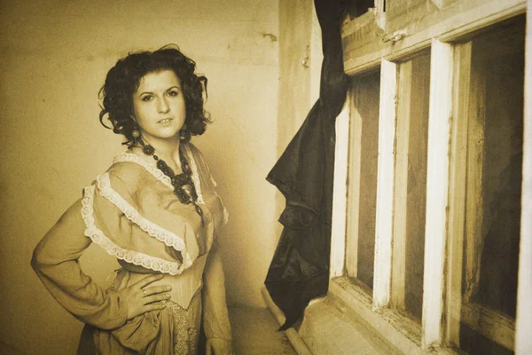 Photo of curly brunette in retro style with sepia effect — Stock Photo, Image