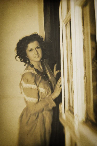 Photo of curly brunette in retro style with sepia effect — Stock Photo, Image