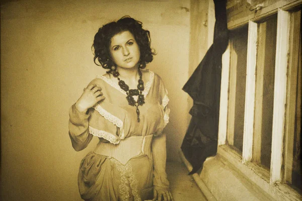 Photo of curly brunette in retro style with sepia effect — Stock Photo, Image