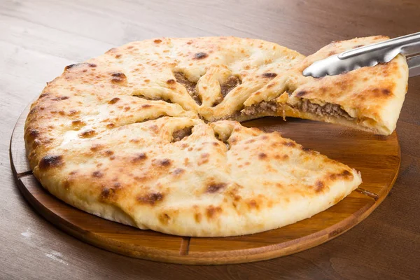 Closed pie with meat stuffing baked in the oven — Stock Photo, Image