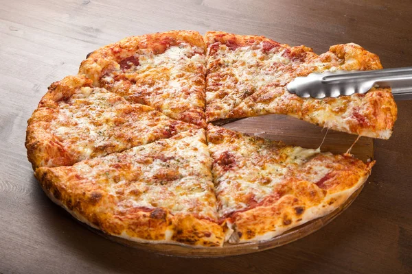 Slice of pizza with toasted cheese — Stock Photo, Image