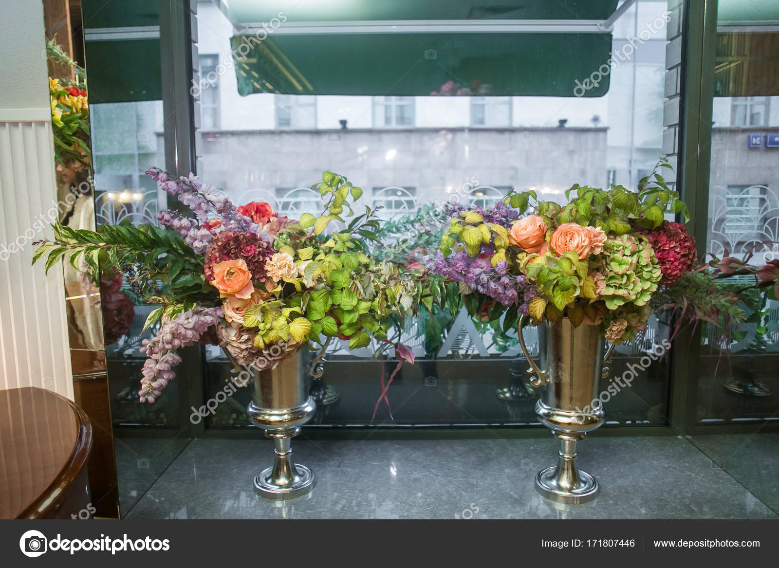 Metal Vases In The Form Of A Goblet With Bouquets Of Flowers Are