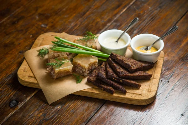 meat in aspic with mustard, greens and black bread