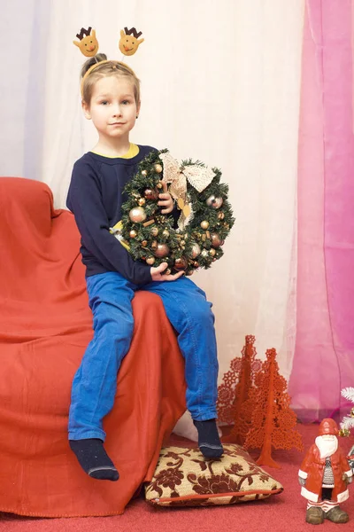 Chlapce Který Seděl Červené Křeslo Vánoční Věnec Rukou — Stock fotografie