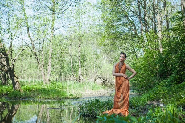 Slim Brunette Orange Dress Standing Shore Forest Pond — Stock Photo, Image