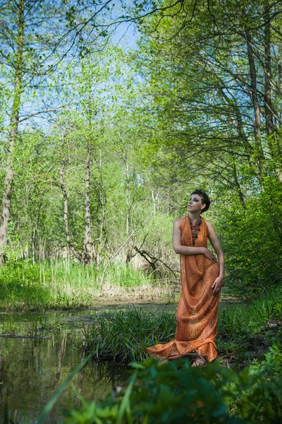 Slim Brunette Orange Dress Standing Shore Forest Pond — Stock Photo, Image