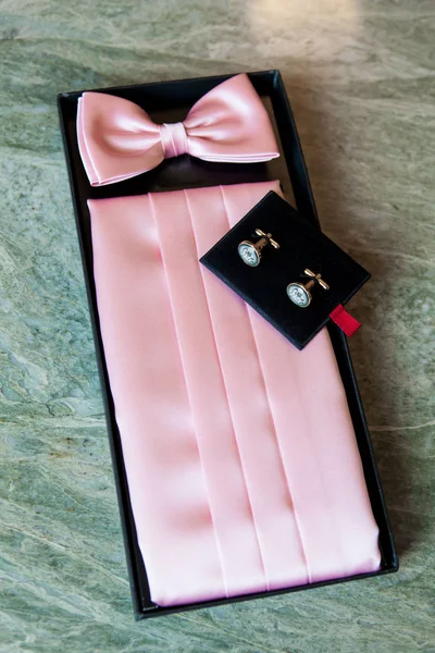 pink bow tie, belt and cufflinks