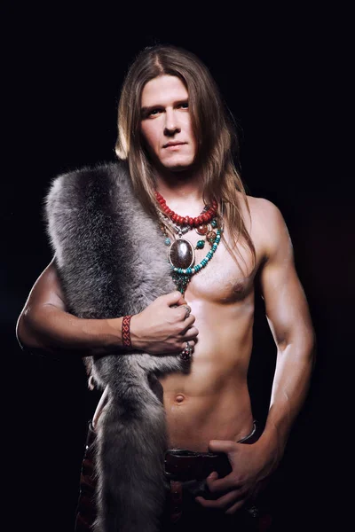 a young naked waist with a man with long hair and a sword in his hands