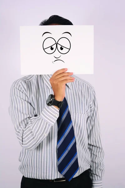 Biznesmen sobie smutną twarz maski — Zdjęcie stockowe