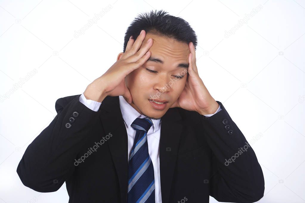 Image of stressed asian businessman having problems and headache at work