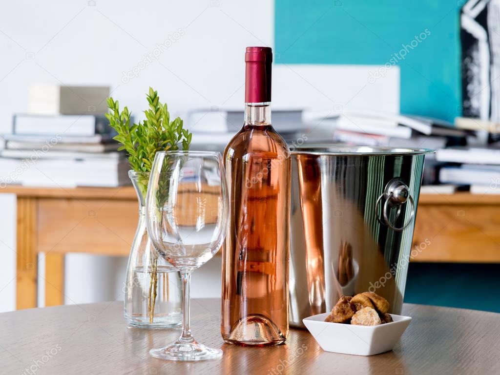 Wine glass and wine bottle on the table