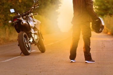 Yolda mesafe içine motosikletçi görünüyor