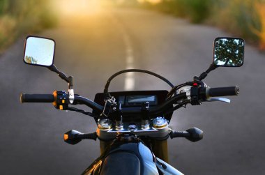 Motosiklet yol ve günbatımı arka planı direksiyon