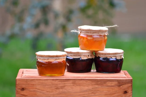 Appetizing sweet jars with honey and jam from natural home ingredients — Stock Photo, Image