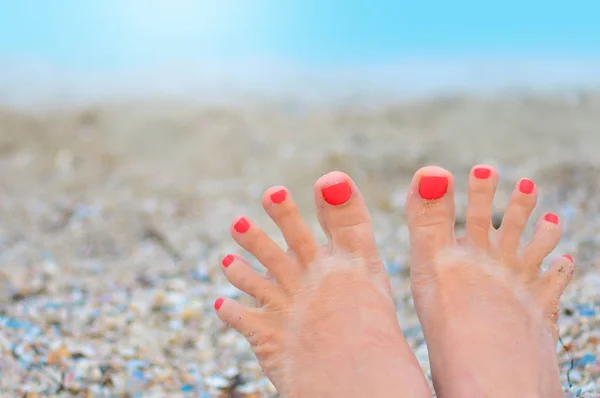 Woman toes with pedicure in a funny trip on a beach — Stock Photo, Image