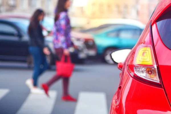 Pedestrians walk along a crosswalk in a lunch hour. Peak hour