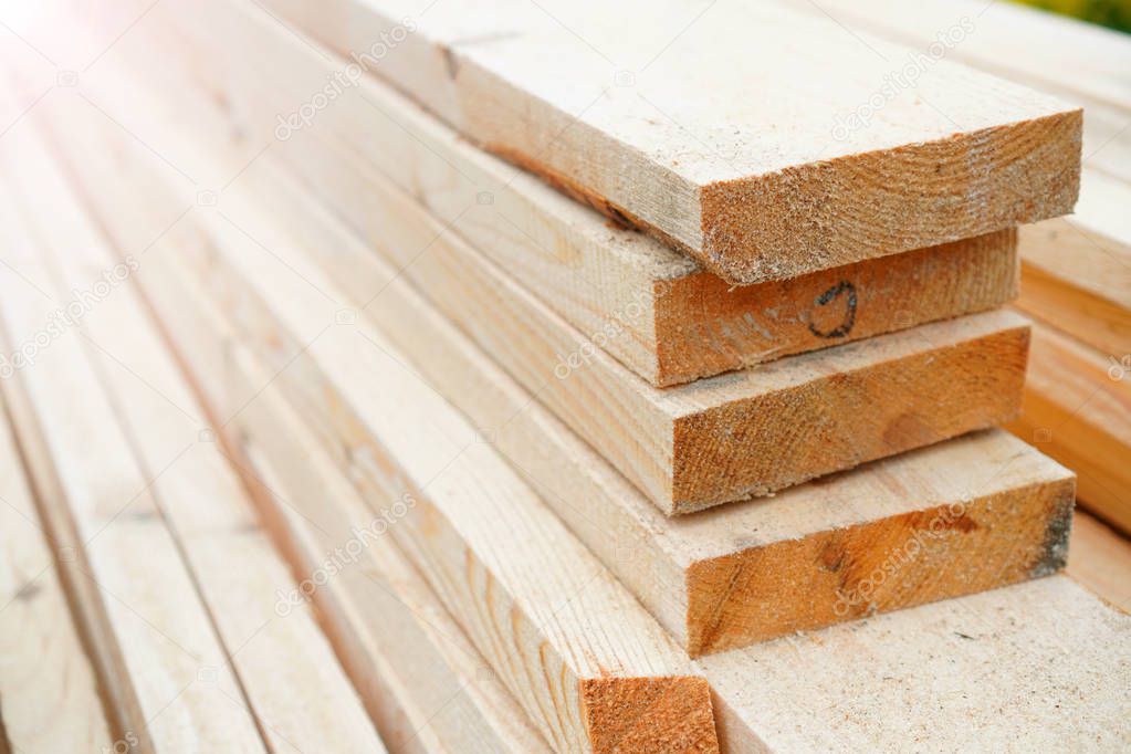 Lumber purchase background. Stack with wooden boards of the same size. Copy space.