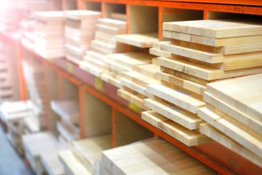 Shelves with lumber and wooden boards. Building warehouse. 